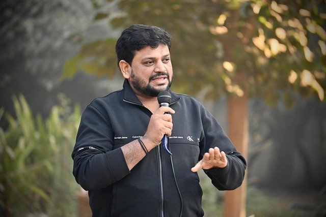 Teacher and construction worker using speaker microphones in different environments.